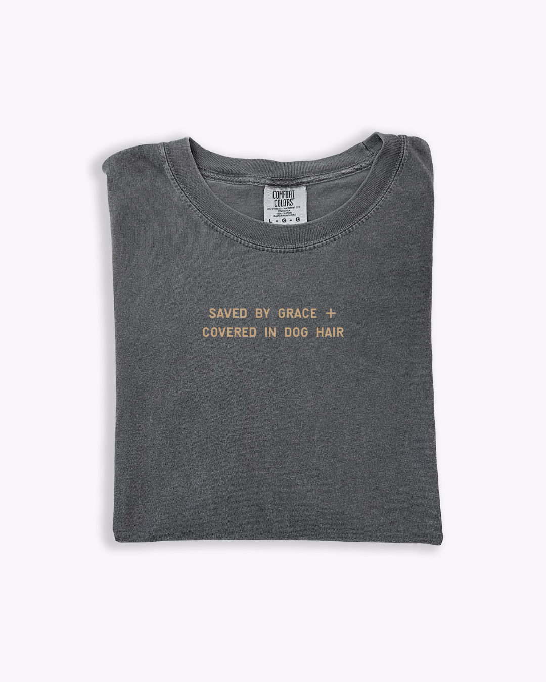 Unisex graphic tee reading Saved by Grace and Covered in Dog Hair on a soft cotton shirt