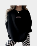 Woman wearing a cotton Mama Minimal Pullover available in Black, White, and Pink colors