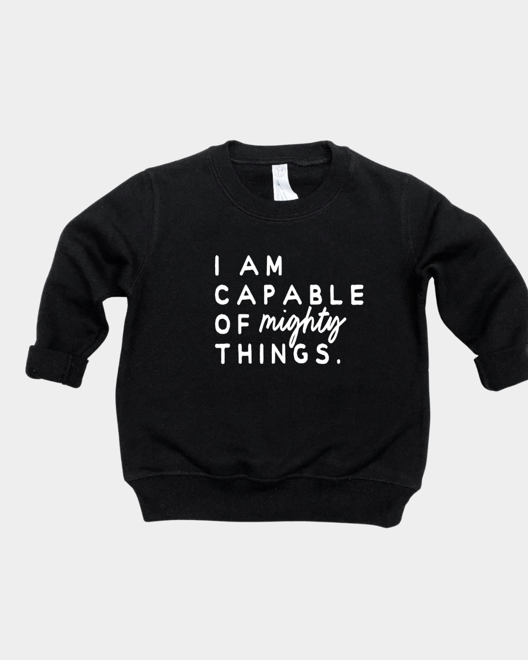 Kids wearing a soft cotton knit pullover with the phrase I am Capable of Mighty Things