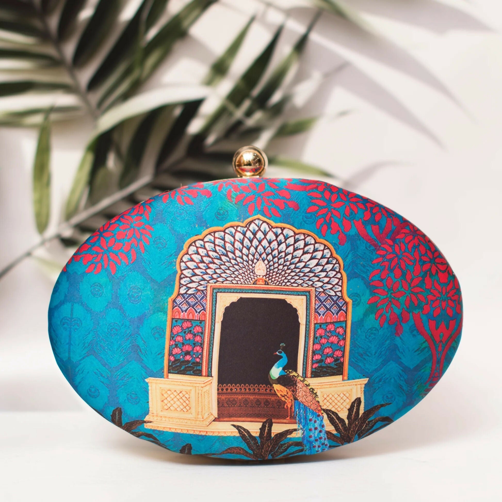 Multicolor bohemian style clutch with blue background and red architectural print