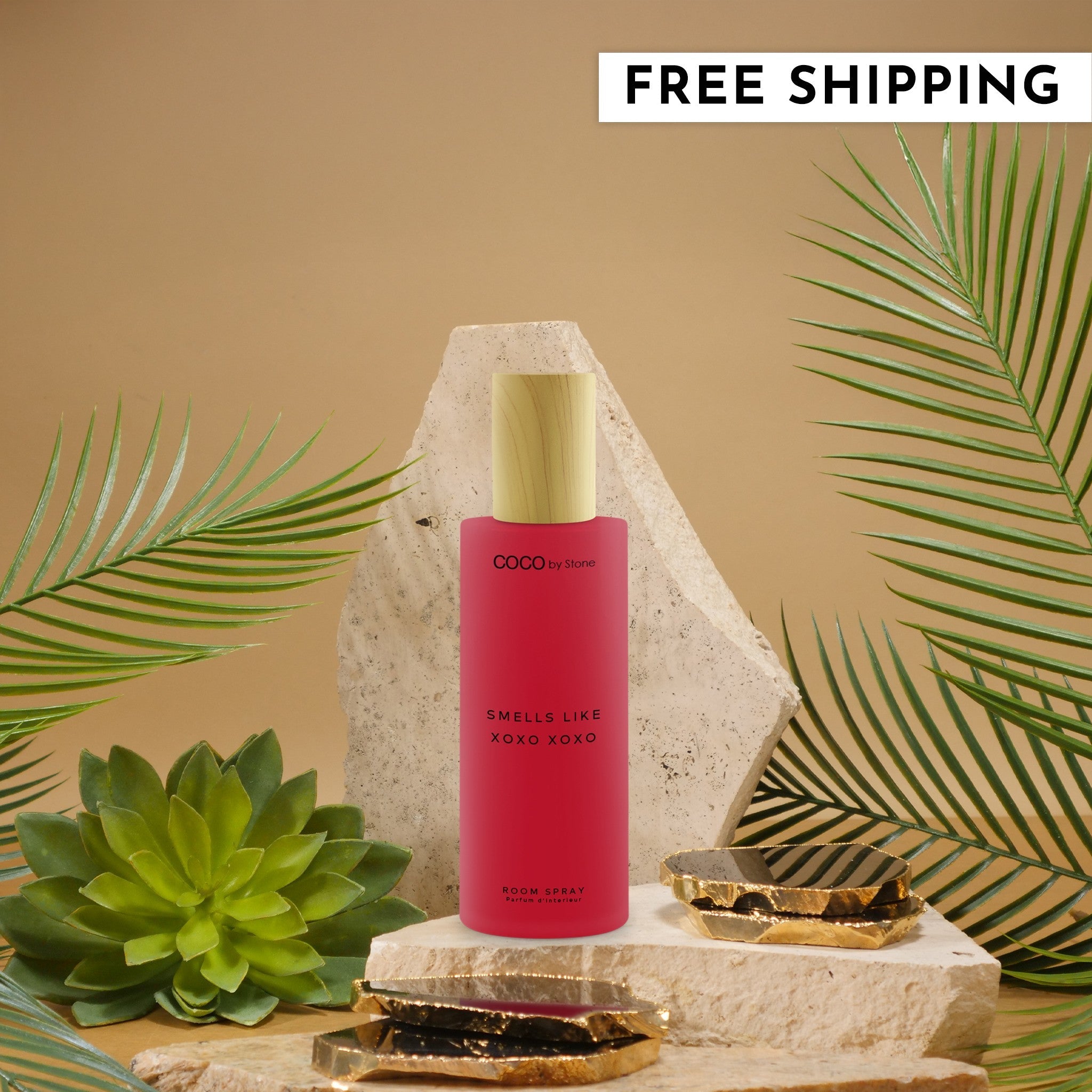 5oz XOXO room spray bottle with pink finish and wood-style cap standing in a decorative indoor setting