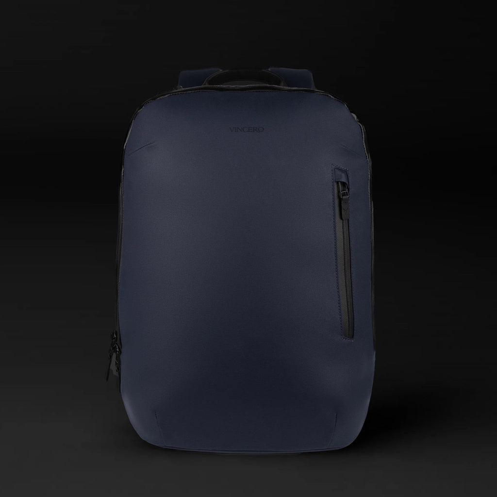 The Commuter backpack in Midnight Blue shown from a side angle, highlighting its sleek urban profile.