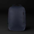 The Commuter backpack in Midnight Blue shown from a side angle, highlighting its sleek urban profile.