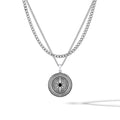 Sterling silver compass pendant featuring a central onyx stone on a classic curb chain.