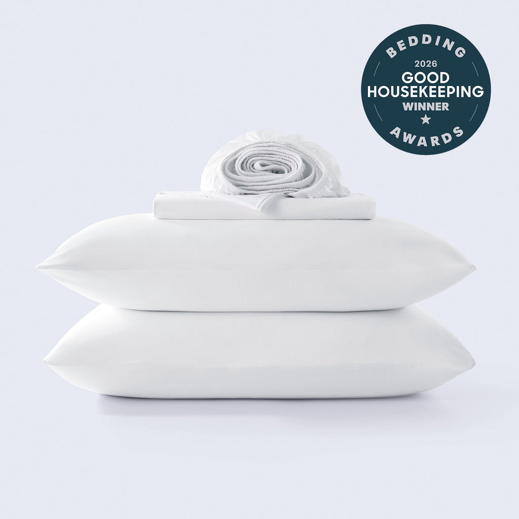 A stack of white cooling sheets with a Good Housekeeping 2026 award winner seal in the corner