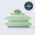 Stack of light green Cool Zone cooling sheets and pillowcases on a white background with a Good Housekeeping 2026 award seal.