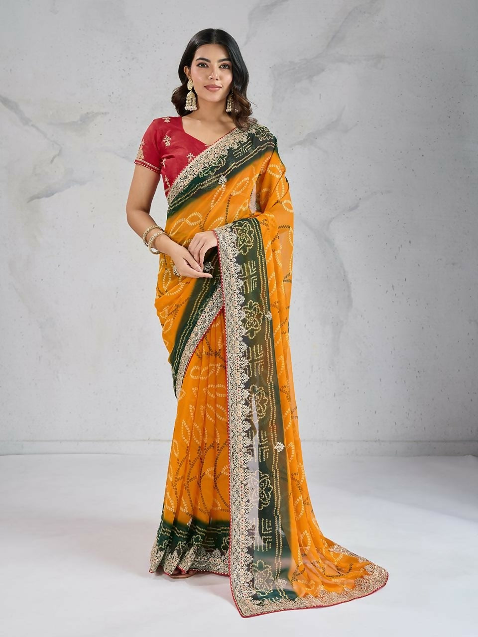 Bright yellow georgette saree featuring digital prints and a contrasting red blouse.
