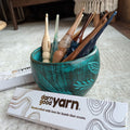 Handcrafted artisanal crochet hook in 4.5MM size with teal, brown, and blue accents.