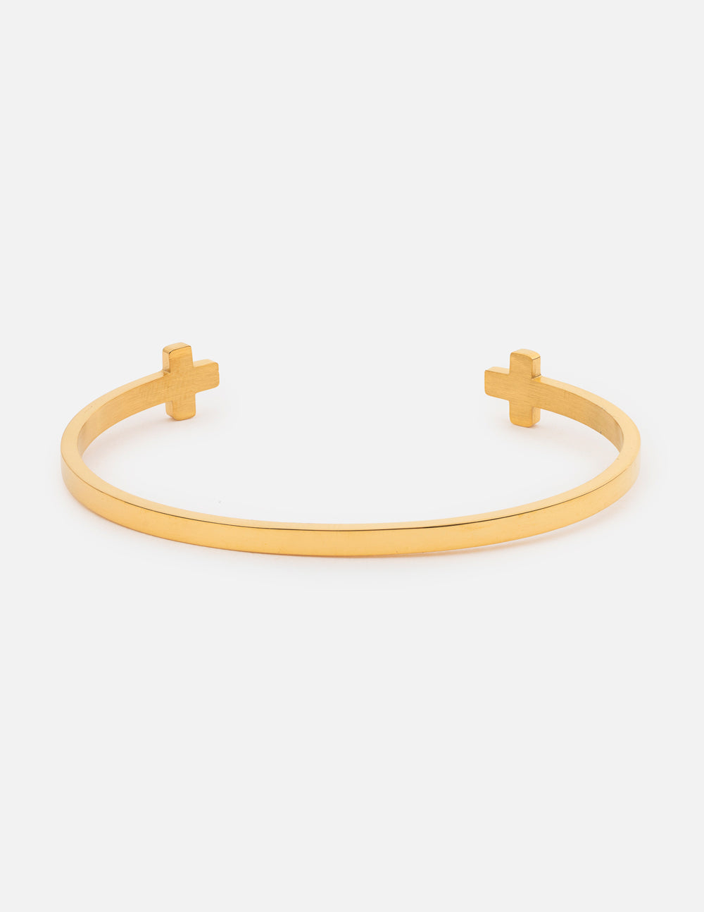 Polished gold minimalist cross cuff bracelet worn on a woman's wrist