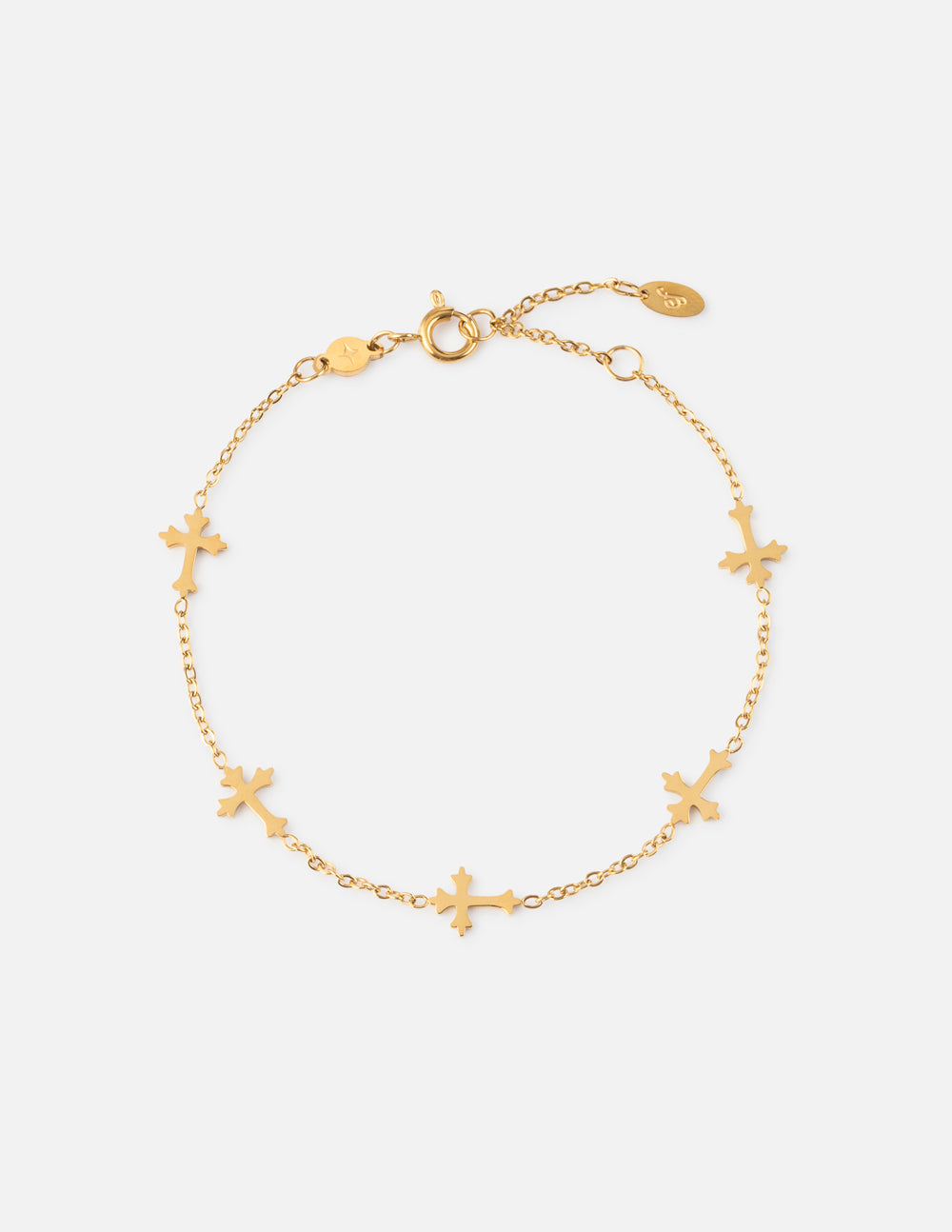 Minimalist polished gold cross link bracelet on a woman's wrist