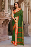 A traditional green and red cotton saree, showcasing its classic color combination and soft fabric drape.