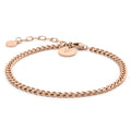 Close up of a polished rose gold Cuban link bracelet on a white background