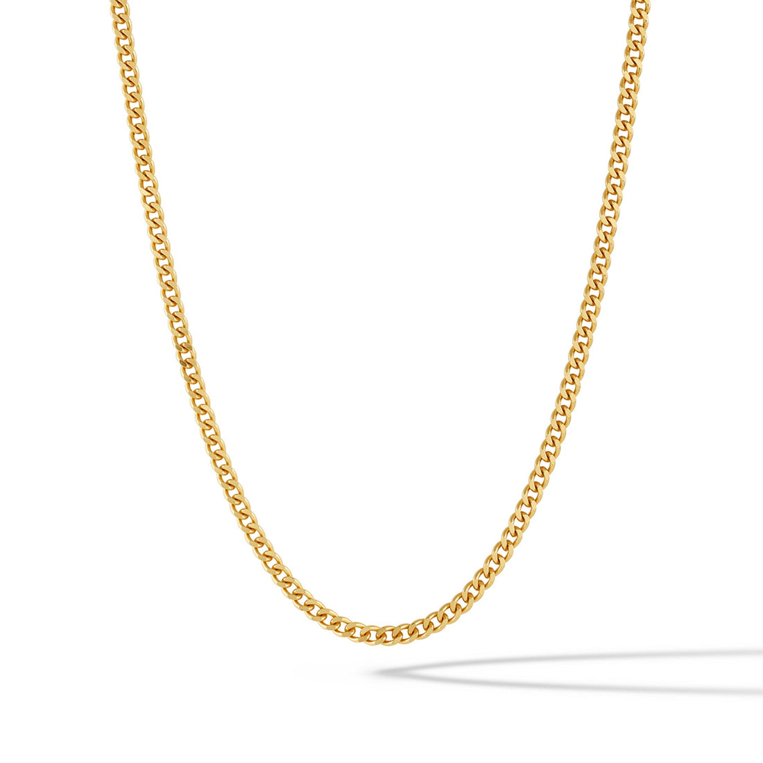 Close-up of a 3mm polished 14k gold plated curb chain necklace resting on a surface.