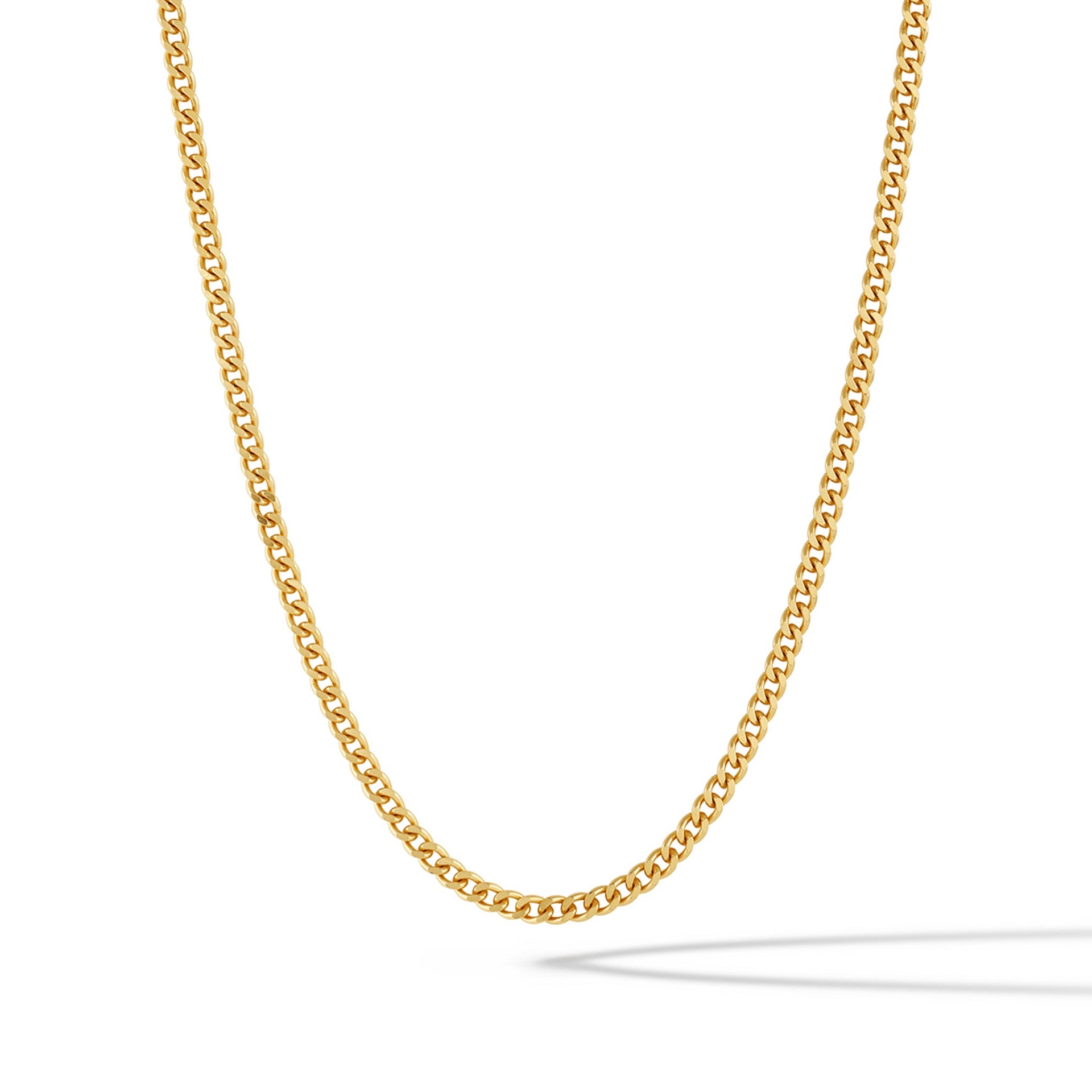 Close-up of a 3mm polished 14k gold plated curb chain necklace resting on a surface.