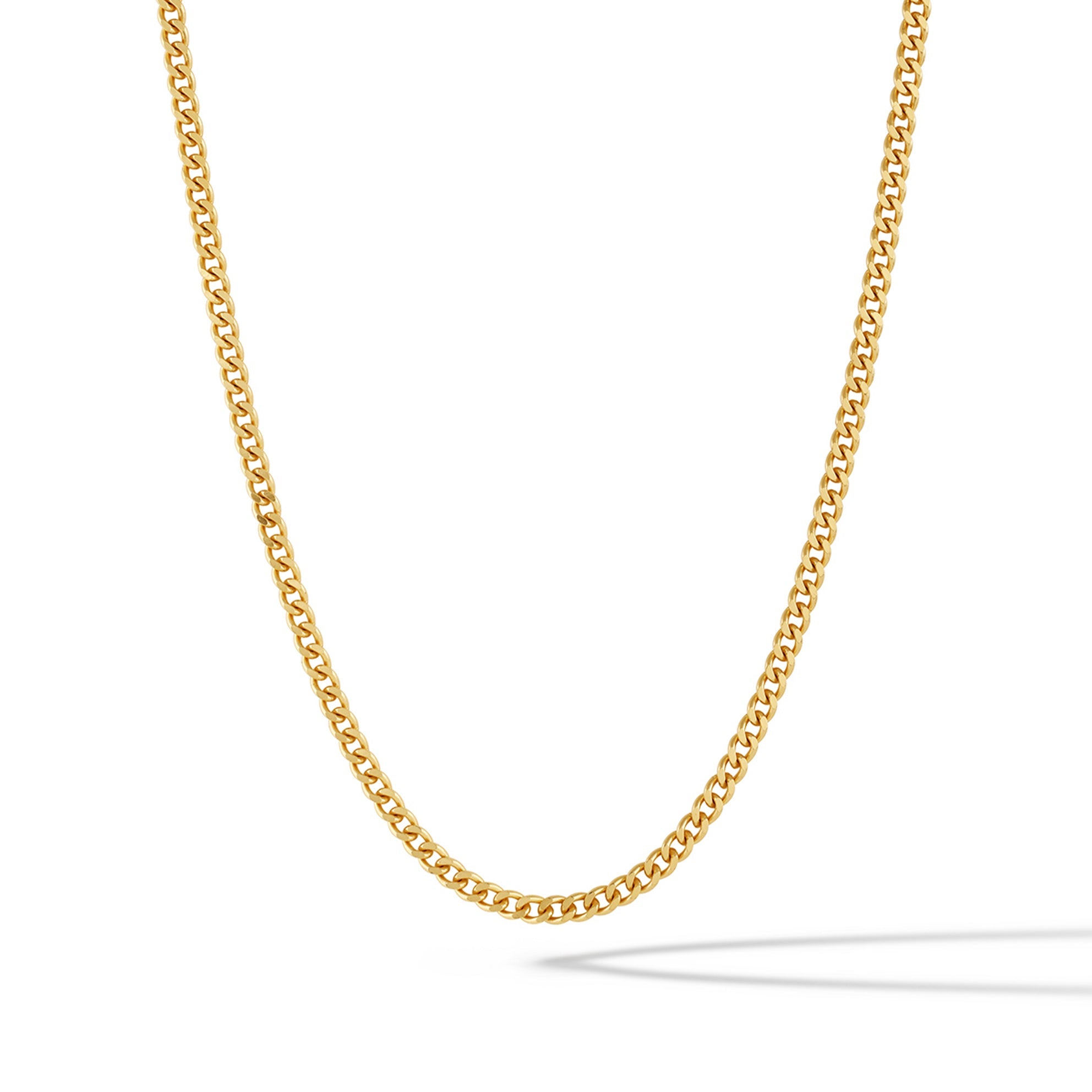 Close-up of a 3mm polished 14k gold plated curb chain necklace resting on a surface.