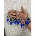 Silver-toned bangle featuring hanging blue pearls and mirror latkan details