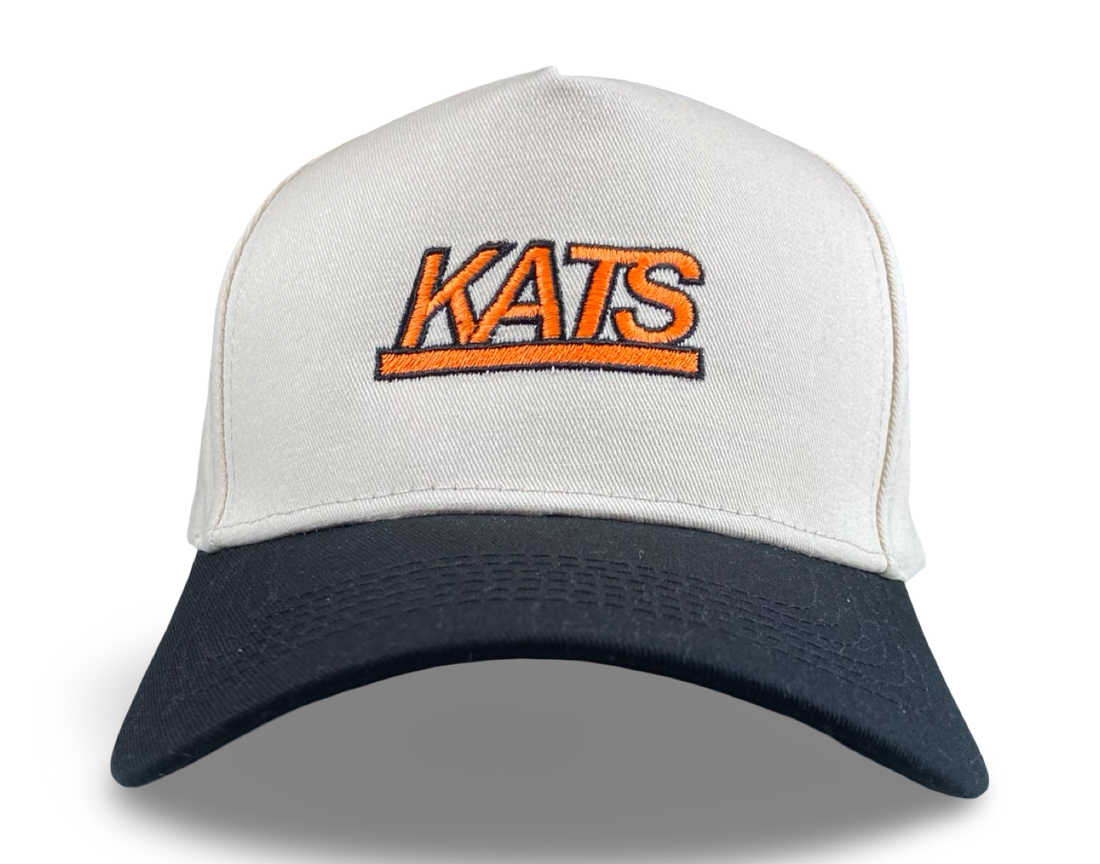 Kats trucker hat with vibrant orange lettering, a white mesh crown, and a navy bill.