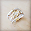 White and gold multi-strand magnetic cuff bracelet with braided leather-look strips and crystal details.
