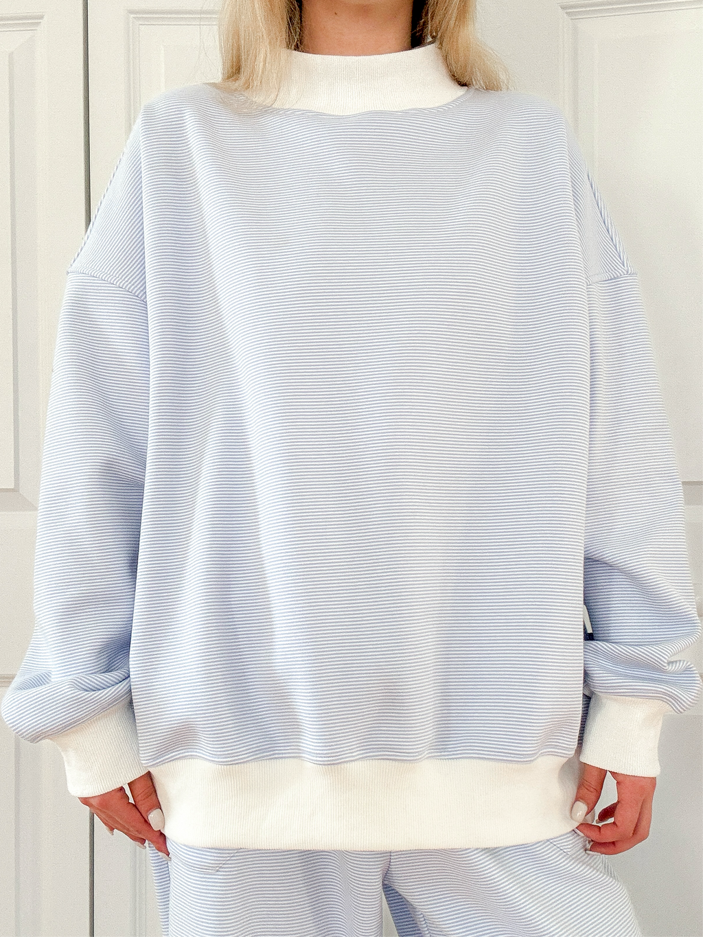 Blue and white mini striped mockneck sweatshirt in a relaxed unisex design.