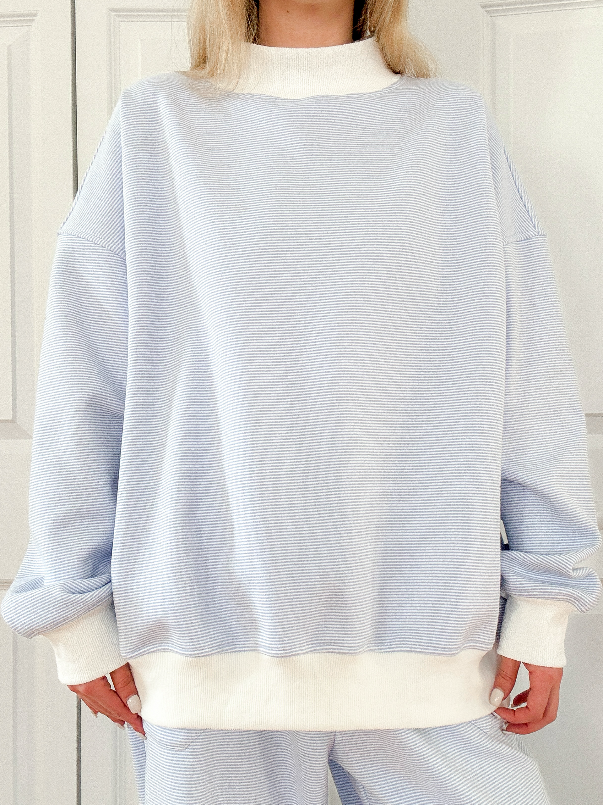 Blue and white mini striped mockneck sweatshirt in a relaxed unisex design.