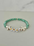 Close up of a PRAY Mint Faceted Beaded Bracelet featuring vibrant mint beads.