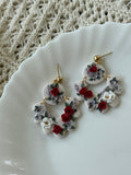Taylor earrings in Love Story floral print with white, red, and green polymer clay and gold accents.