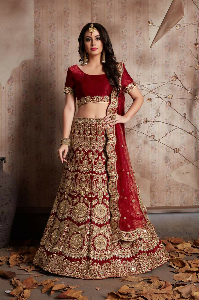 Vibrant red velvet lehenga with elaborate sequin and mirror work embroidery