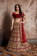Vibrant red velvet lehenga with elaborate sequin and mirror work embroidery