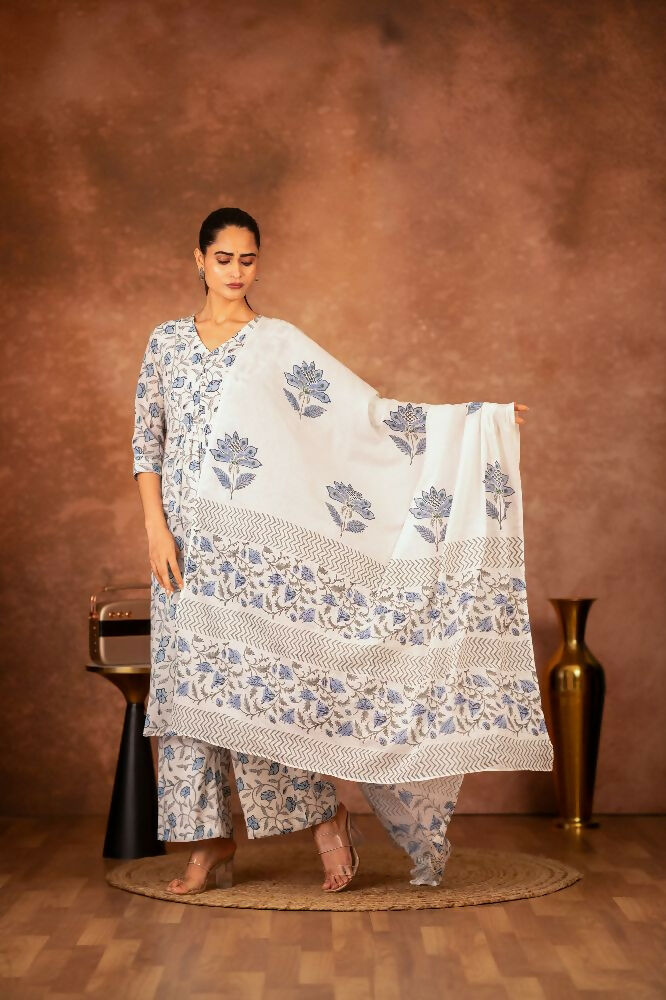 A woman wearing a blue hand block printed cotton suit set with intricate patterns.