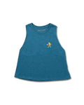 A woman wearing a teal blue racerback cropped tank top while playing pickleball on a court.