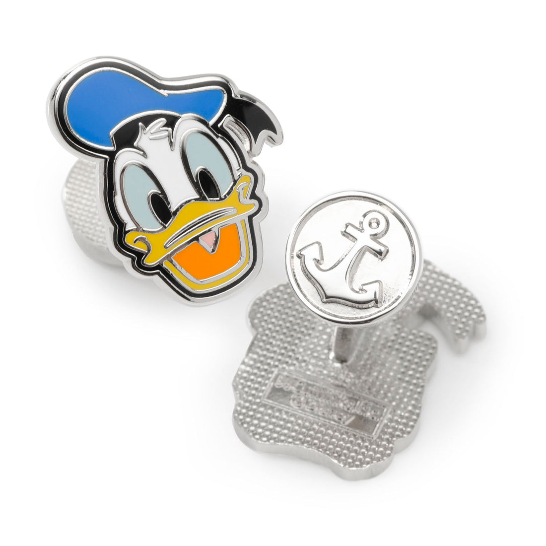 A pair of Disney Donald Duck cufflinks showing two different facial expressions with blue, white, yellow, and orange enamel details on a silver-tone metal base.