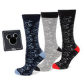 Three pairs of Disney Donald Duck crew socks in black, blue, and gray with a black Mickey Mouse silhouette lapel pin in gift packaging