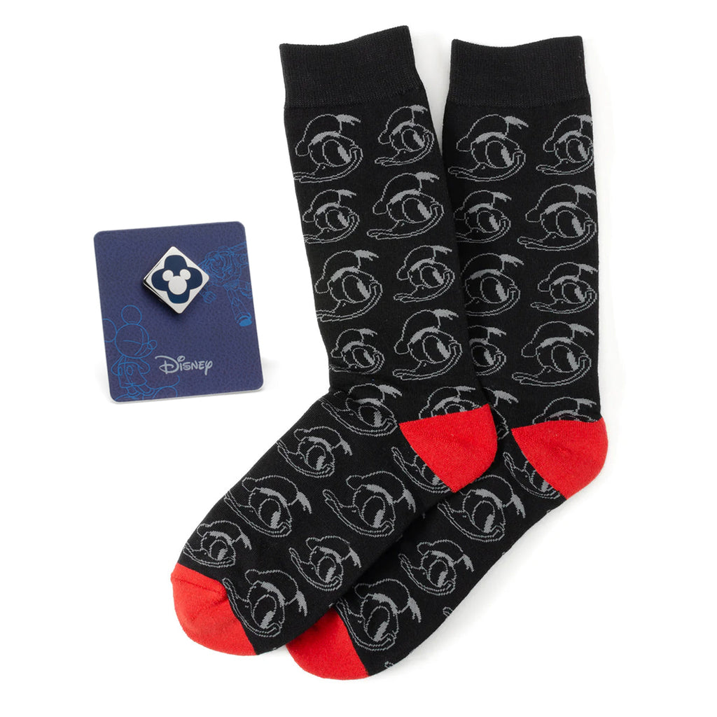 Disney gift set featuring black Donald Duck patterned socks with red heels and toes, alongside a blue Mickey Mouse enamel lapel pin.
