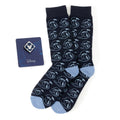 A gift set containing navy blue crew socks with a Donald Duck pattern and a blue and white Mickey Mouse lapel pin.