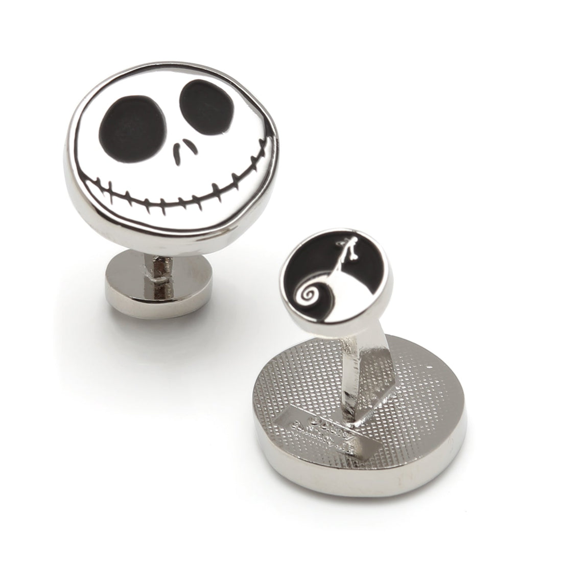 Close-up of circular silver and black Jack Skellington cufflinks showing the character face and logo backing.