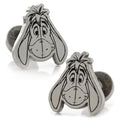 A pair of silver plated Disney Eeyore cufflinks showing the character face on the front and his tail on the round backing.