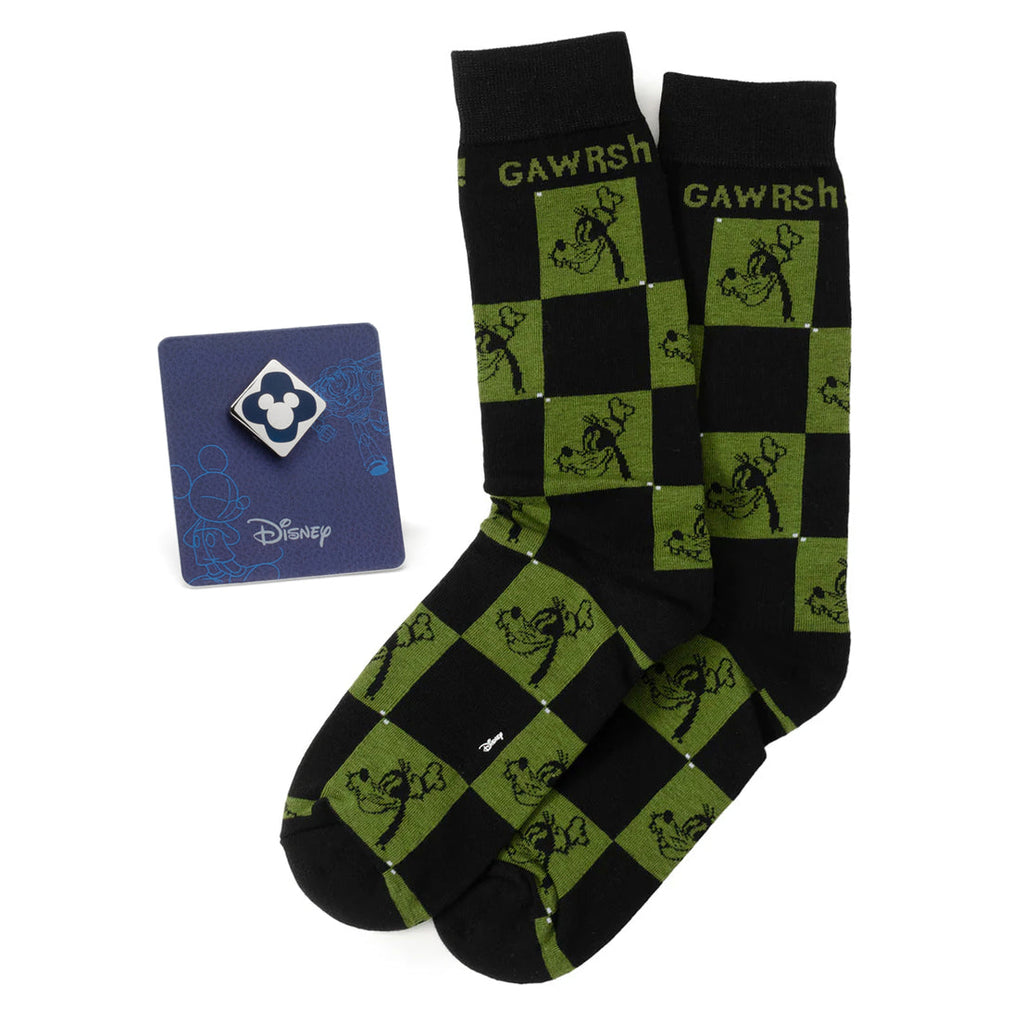 A pair of black and green checkered socks featuring Goofy next to a blue Mickey Mouse enamel lapel pin on a display card.