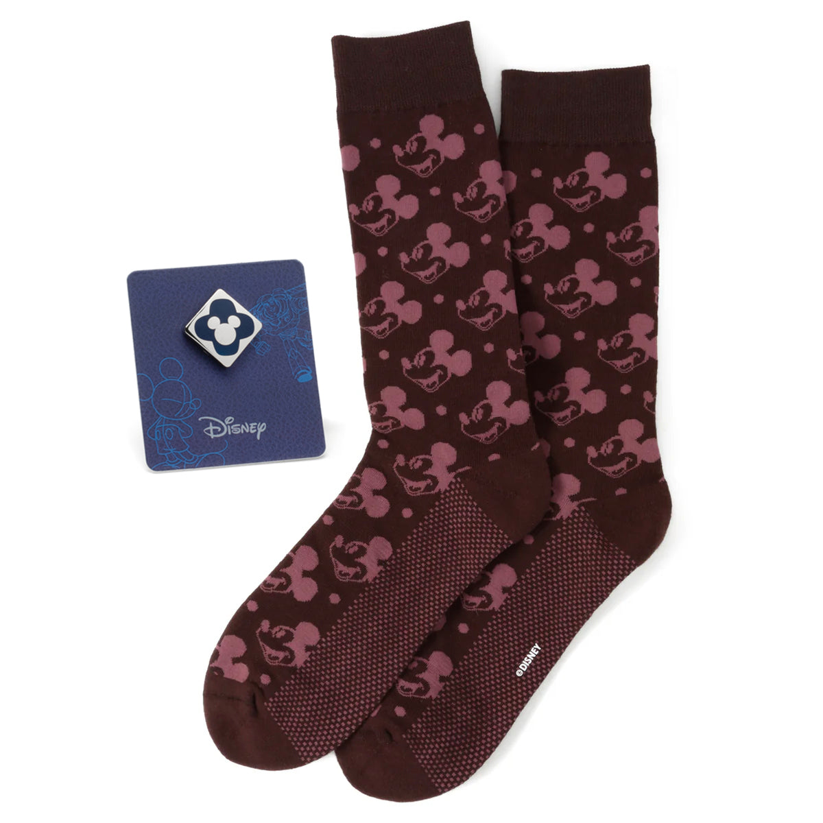 A pair of brown socks with a pink Mickey Mouse pattern next to a blue Mickey Mouse enamel lapel pin.