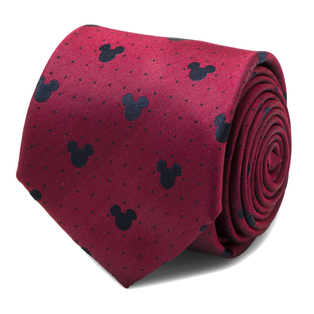 Close up of a deep red silk necktie featuring a dark pin dot pattern and small Mickey Mouse head icons