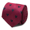 Close up of a deep red silk necktie featuring a dark pin dot pattern and small Mickey Mouse head icons