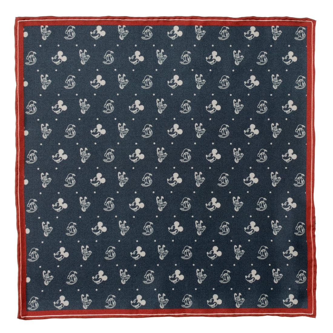 A navy silk pocket square with a white print of Mickey Mouse, Donald Duck, and Pluto with a burgundy border, displayed flat and inside a suit jacket pocket.