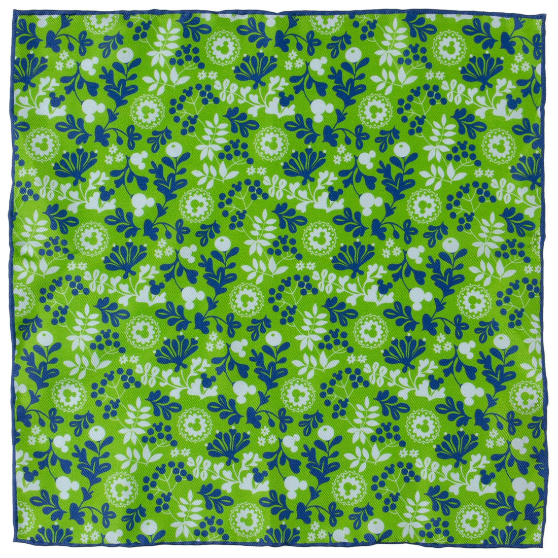A close up view of a green silk pocket square with a floral pattern and hidden Mickey Mouse icons, folded in a suit jacket pocket.