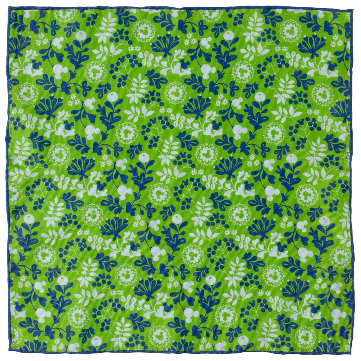 A close up view of a green silk pocket square with a floral pattern and hidden Mickey Mouse icons, folded in a suit jacket pocket.