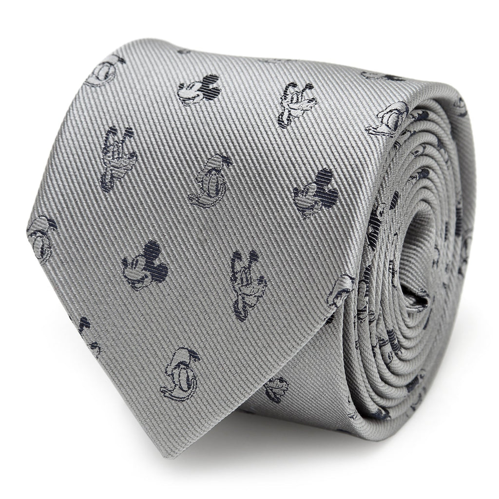Close-up of a gray silk men's necktie featuring small black patterned motifs of Mickey Mouse, Donald Duck, and Pluto.