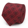 A festive red silk necktie with a black geometric pattern and Mickey Mouse icons, displayed on a suit and shirt.