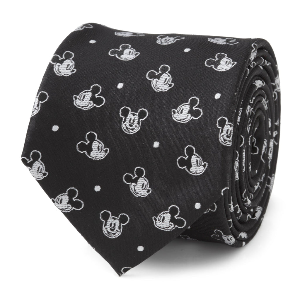 A black men's necktie featuring a repeating white pattern of various Mickey Mouse faces and small white dots.