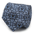 A close-up view of a blue silk necktie with a black damask pattern and hidden Mickey Mouse icons.