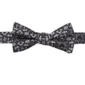 Close up of a gray and black silk bow tie featuring a damask pattern with hidden Mickey Mouse silhouettes.