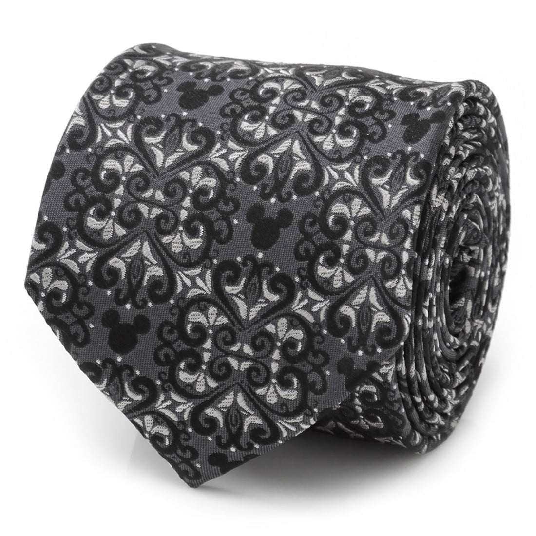 Close up of a gray and silver silk tie with a damask pattern and hidden Mickey Mouse motifs rolled on a white surface.
