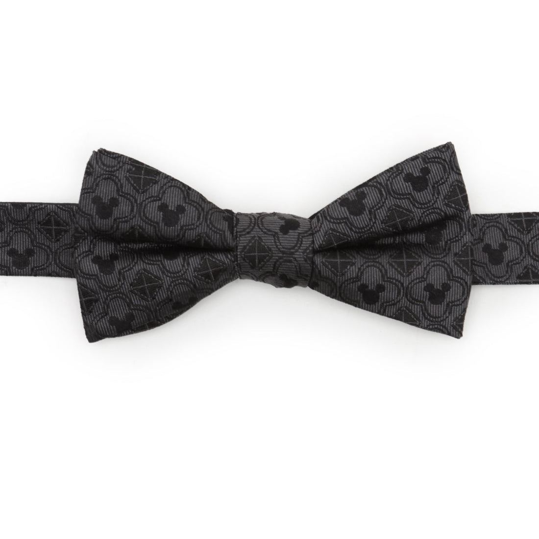 Close-up of a black silk bow tie featuring a repeating Mickey Mouse silhouette and diamond geometric pattern.